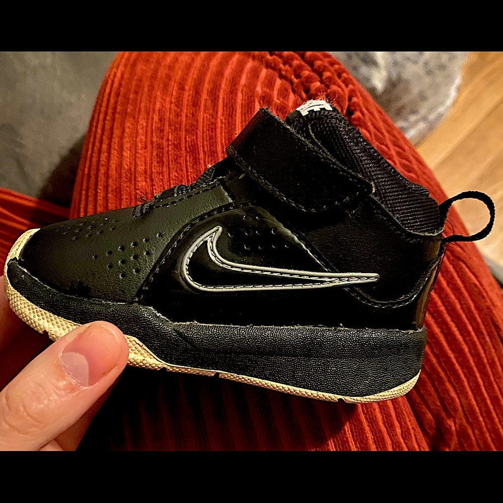 Baby’s black Nike shoes